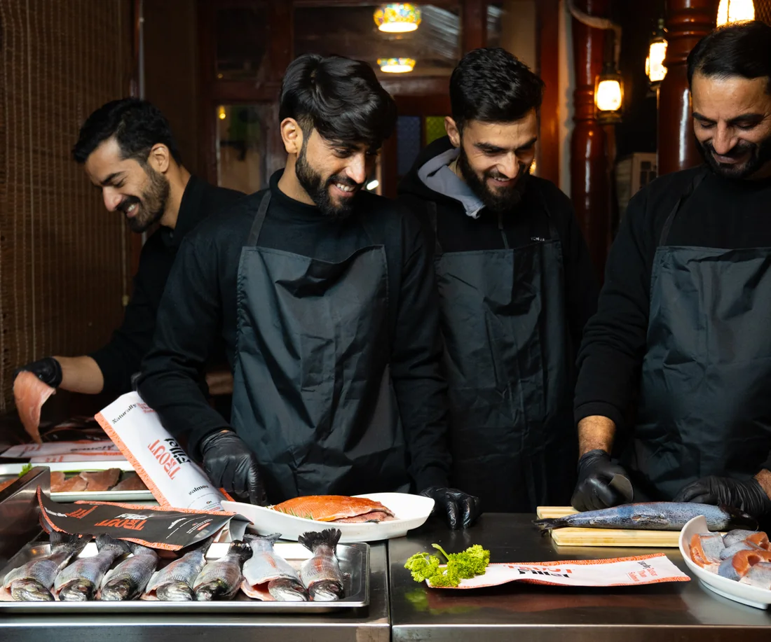 Team preparing fish at the counter